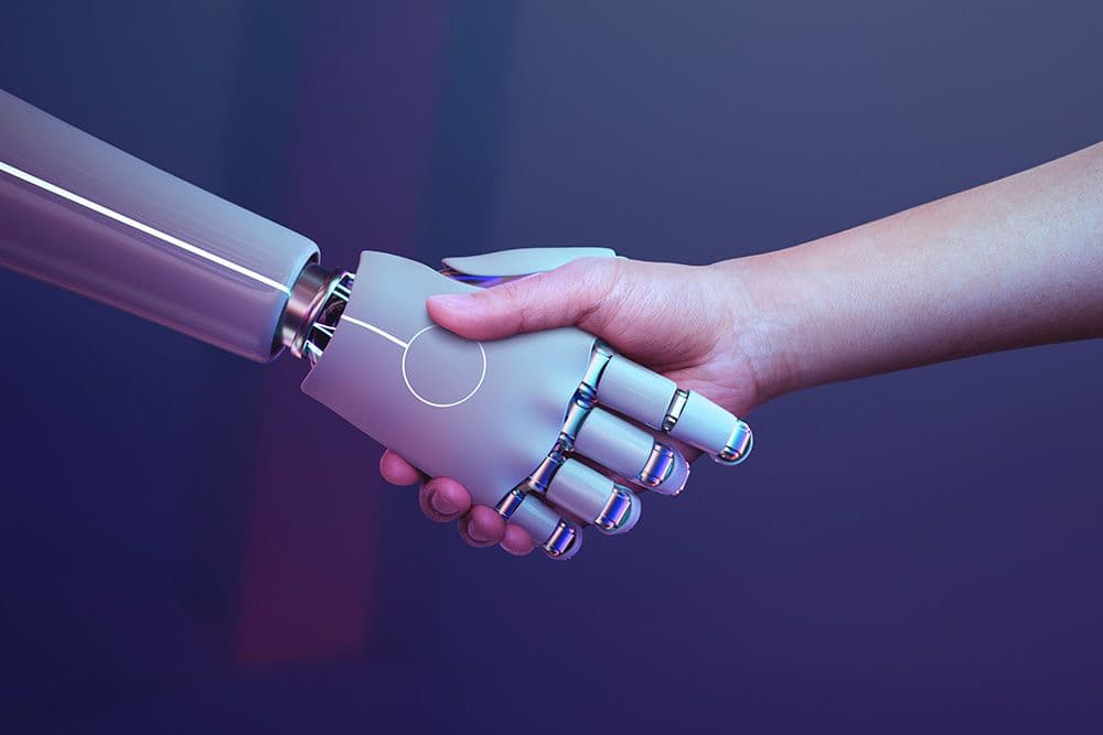 the hand of a robot and a human